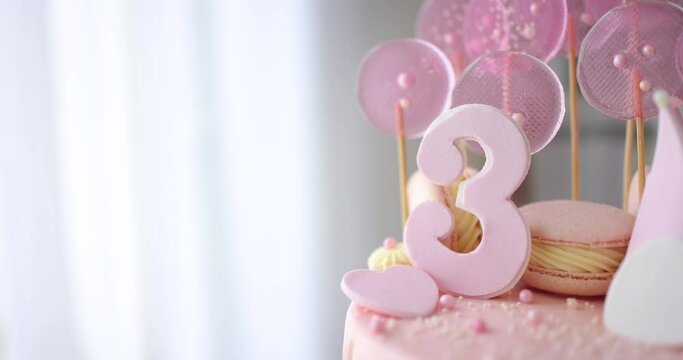 decorated birthday cake with hearts, crown and sugar beads for three years old baby girl