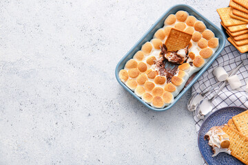 Composition with delicious S'mores dip and crackers on light background