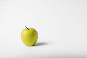 Green and yellow apple on a white background
