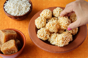 Murmura ladoo laddu woman hand puffed rice ball 
pori urundai Indian festival food snack sweet Lohri Makar Sankranti Pongal Diwali harvest winter folk festival Tamil Nadu Punjab North India. 