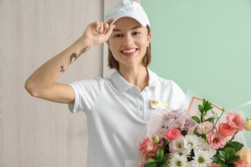 Female courier with bouquet of flowers in hall