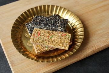 Til chikki peanut chikki Murmura ladoo laddu Revdi popcorn Indian festival food snack sweet Lohri Makar Sankranti Pongal Diwali harvest festival Tamil Nadu winter folk festival Punjab North India. 