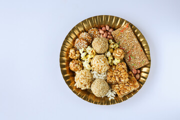 Til chikki peanut chikki Murmura ladoo laddu Revdi popcorn Indian festival food snack sweet for Lohri Makar Sankranti Pongal Diwali harvest festival Tamil Nadu winter folk festival Punjab North India
