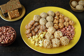 Til chikki peanut chikki Murmura ladoo laddu Revdi popcorn Indian festival food snack sweet for Lohri Makar Sankranti Pongal Diwali harvest festival Tamil Nadu winter folk festival Punjab North India