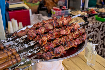 Healthy street food to go - kebab on skewers. Delicious food cooked over an open fire, which is offered at a street food fair, event, festival.