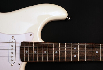 Obraz na płótnie Canvas White electric guitar on a dark background close up