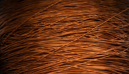 Enameled copper wire wound on a large spool.