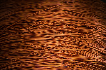 Enameled copper wire wound on a large spool.