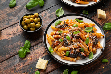 Pasta alla Norma with eggplant or aubergine, tomato, parmesan and basil. Healthy food