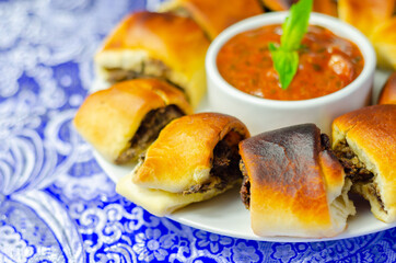 Patties pies stuffed with minced meat, mushrooms and onion, served with sauce