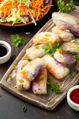 Fried Vegan spring rolls, rice paper dumplings with sweet and purple cabbage, rice noodles and carrots