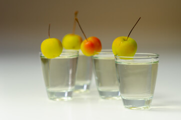 Delicious Calvados served in shot glasses decorated with crab apples