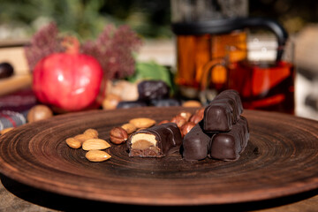 Chocolate on the brown plate. Copy space. Close up.Sunshine outside. 