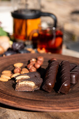 Chocolate candy on brown dish. Close-up. Copy space.
Handmade chocolate. Vegan candy.
