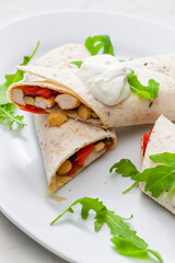 tortilla filled with chicken meat, red pepper and beans
