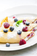 pankaces filled with blueberries, raspberries and cream