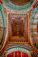 Thanjavur, Tamil Nadu, India - The high arches artworks and colorfully painted wall murals and ceilings of the ancient 17th-century durbar hall Maratha Palace in the town of Thanjavur