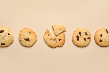 Delicious homemade cookies with chocolate chips on beige background