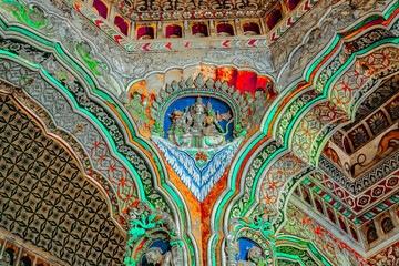 Thanjavur, Tamil Nadu, India - The high arches artworks and colorfully painted wall murals and ceilings of the ancient 17th-century durbar hall Maratha Palace in the town of Thanjavur