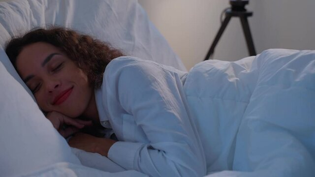 Latino beautiful comfort girl in pajamas sleep in dark night in bedroom	