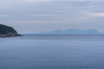 Fototapeta na wymiar Blick Richtung Isola del Elba, Toskana, Italien mit Wolken und Bergen