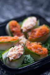 set of sushi rolls with seafood on a black stone background