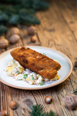 Traditional Christmas dinner in Czech Republic - carp fillet with potato salad