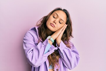 Young hispanic girl wearing casual clothes sleeping tired dreaming and posing with hands together while smiling with closed eyes.