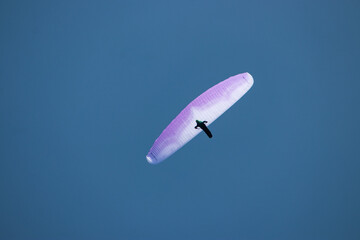 single person paragliding open clear sky blue background Pokhara 