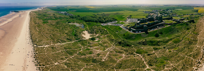 England, Northumberland, Bamburgh Castle on hill near beach