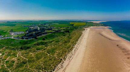 England, Northumberland, Bamburgh Castle on hill near beach