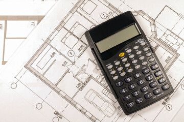 Mortgage calculation of a private country house under construction in the future. The calculator is on the house plan. 