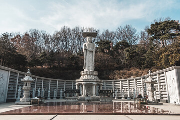 White stone big buddha statue. Large white Buddhist statue in the park.