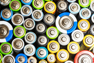 Colorful top view of cylindrical used batteries