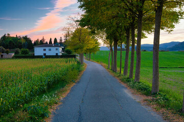 View of a path that leads to a rural house at sunset in the Malla valley. Osona, Catalonia -