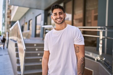 Handsome hispanic man smiling happy outdoors