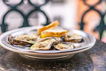 Oysters on the half shell on a table on a balcony in the French Quarter, in New Orleans, Louisiana....