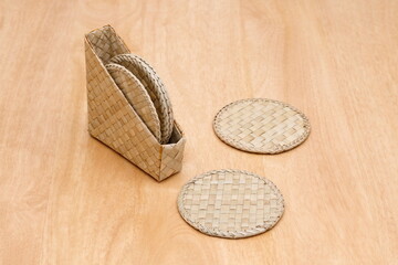 detail of wicker coasters on wooden table