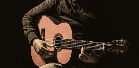 Obraz premium Acoustic guitars playing. Music concept. Guitars acoustic. Live music. Man's hands playing acoustic guitar, close up. Music festival. Male musician playing guitar, music instrument