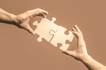 Hand connecting jigsaw puzzle. Business solutions, success and strategy concept. Man hands connecting couple puzzle piece. Business solutions, target, success, goals and strategy concepts