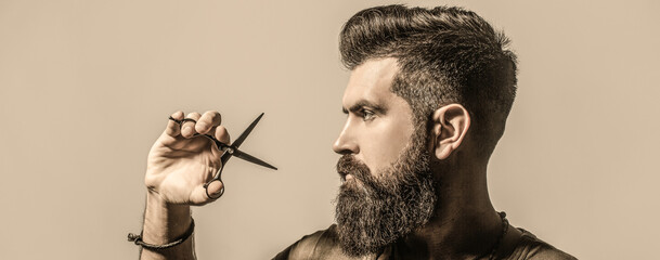 Male in barbershop, haircut, shaving. Bearded man isolated on gray background. Mans haircut in...