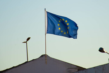 Flag of the European Union waving in the wind, symbol of the economic unity of many European countries.