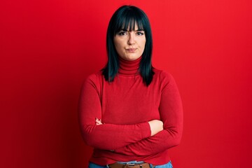 Obraz premium Young hispanic woman with arms crossed gesture skeptic and nervous, frowning upset because of problem. negative person.