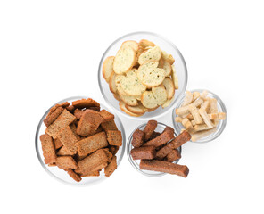 Different crispy rusks in bowls on white background, top view