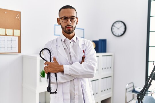 African american doctor man holding stethoscope at the clinic skeptic and nervous, frowning upset because of problem. negative person.