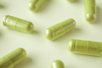 Herbal medicine capsules on white background