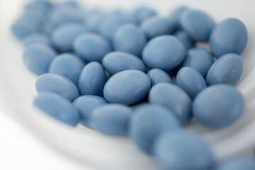 blue medicine pills with bottle on white background