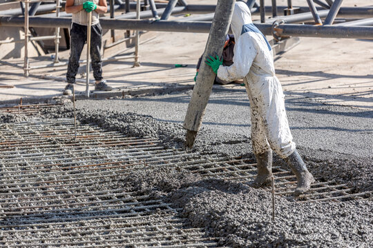 Pouring out concrete with ready-mix concrete (RMC) in the construction site. Ready mix concrete is a batch of concrete that is mixed before being delivered.