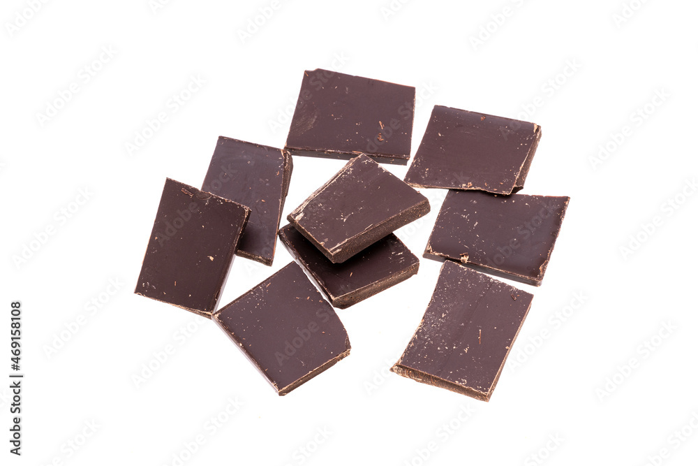 Poster dark chocolate bars in heap isolated on white background