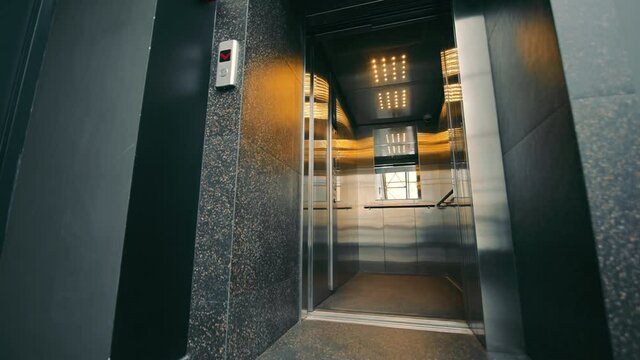 Elevator doors open. the elevator doors open and close. An empty summer without people.